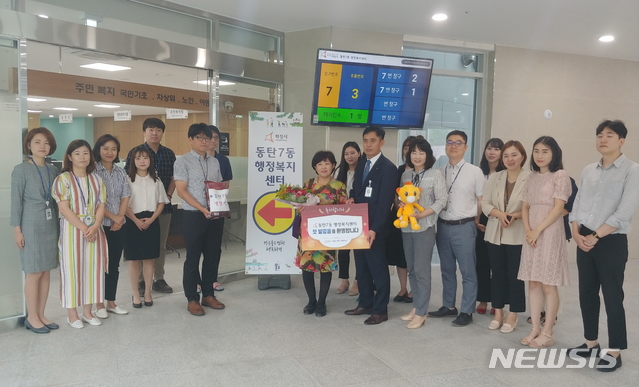 【화성=뉴시스】 화성시 동탄7동주민자치센터에 처음으로 방문한 김복순씨가 환영식을 가진 뒤 기념촬영을 하고 있다.(사진 = 화성시 제공)