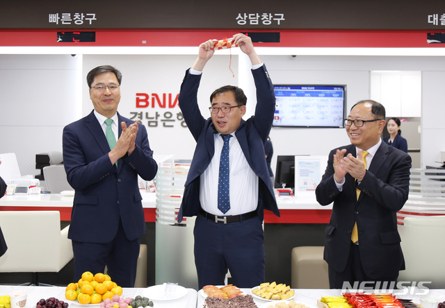 【창원=뉴시스】홍정명 기자= 1일 경기도 하남시 BNK경남은행 하남미사역지점 개점 기념식에서 이동현(가운데) 지점장이 서울영업본부 여창현(왼쪽) 상무대우로부터 전달받은 금고 열쇠를 들어보이고 있다.2019.07.01.(사진=BNK경남은행 제공) photo@newsis.com