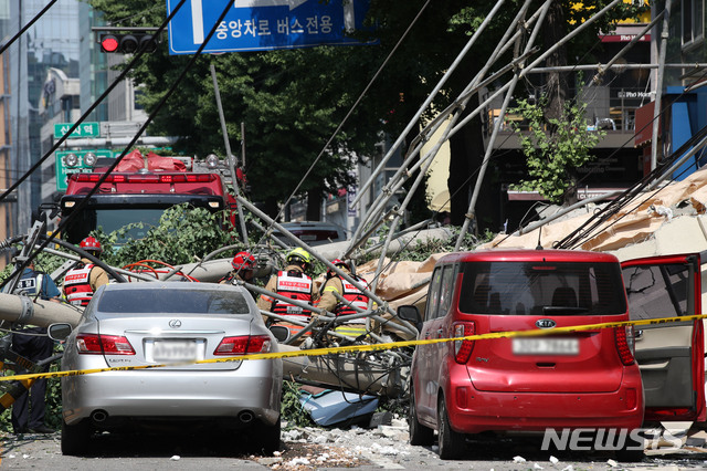 [서울=뉴시스]김선웅 기자 = 지난해 7월4일 오후 서울 서초구 잠원동의 한 철거 중인 건물 외벽이 붕괴하는 사고가 발생했다. 인근 차량이 사고 영향으로 넘어진 전신주에 깔려 있다. 2019.07.04. mangusta@newsis.com