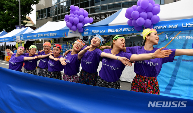 【광주=뉴시스】 신대희 기자 = 광주FINA세계수영선수권대회 개막을 하루 앞둔 11일 광주 동구 금남로에서 열린 시민 어울마당 행사에서 '광주, 엄마가 달린다' 회원들이 아티스틱 스위밍을 통해 평화의 메시지를 전하고 있다. 2019.07.11. sdhdream@newsis.com