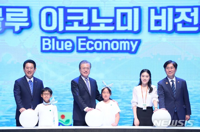 【무안=뉴시스】전신 기자 = 문재인 대통령이 12일 전남 무안군 전남도청에서 열린 전남 블루이코노미 경제비전 선포식에서 참석자들과 함께 대형 블루 이코노미 볼을 터치하는 세리머니를 하고 있다.&nbsp; 왼쪽부터 김영록 전남지사, 문 대통령, 성윤모 산업통상자원부 장관. 2019.07.12.&nbsp; photo1006@newsis.com