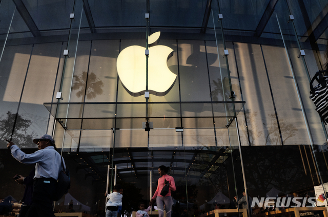 FILE - In this June 15, 2019, file photo customers leave an Apple store on the 3rd Street Promenade in Santa Monica, Calif. Apple Inc. reports financial results on Tuesday, July 30. (AP Photo/Richard Vogel, File)