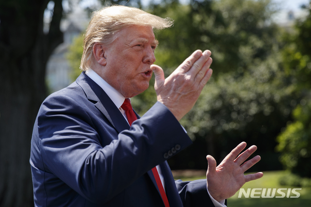 President Donald Trump speaks to media as he arrives at the White House in Washington, Tuesday, July 30, 2019, as the returns from Virginia. (AP Photo/Carolyn Kaster)