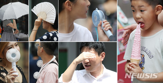 【서울=뉴시스】김진아 기자 = 서울·경기일부 등에 폭염경보가 내려진 2일 서울 중구 명동에서 관광객과 시민들이 휴대용 선풍기, 부채 등을 이용해 더위를 식히고 있다. 2019.08.02.&nbsp; bluesoda@newsis.com