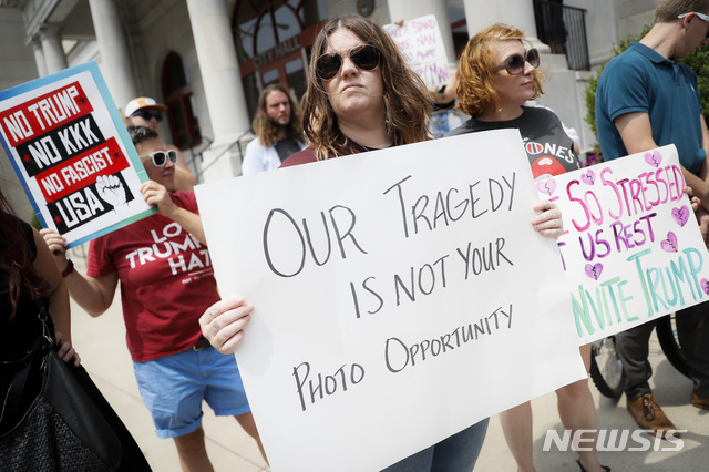 【데이턴=AP/뉴시스】6일(현지시간) 미 오하이오주 데이턴 시청사 앞에서 시위대가 "우리의 참사는 당신의 사진 찬스가 아니다" "트럼프 반대" 등의 손팻말을 들고 도널드 트럼프 대통령 방문 반대 시위를 벌이고 있다. 2019.08.07.&nbsp; 