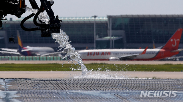 [인천공항=뉴시스] 김진아 기자 = 뜨거워진 인천공항 활주로에 살수차와 소방차가 살수작업을 실시하고 있다. 2024.08.18. bluesoda@newsis.com