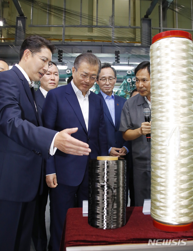 【전주=뉴시스】전신 기자 = 문재인 대통령이 20일 오후 전북 전주시 효성첨단소재㈜ 전주공장에서 열린 탄소섬유 신규투자 협약식이 끝난 뒤 탄소섬유가 플라스틱 저장용기를 감아서 성형하는 수소저장용기 제작 과정을 살펴보고 있다. 2019.08.20. photo1006@newsis.com