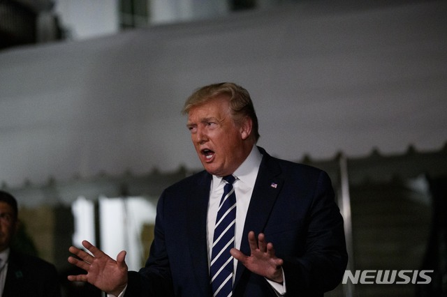 President Donald Trump speaks with reporters as he walks to Marine One on the South Lawn of the White House, Friday, Aug. 23, 2019, in Washington. Trump is en route to the G-7 summit in France. (AP Photo/Alex Brandon)