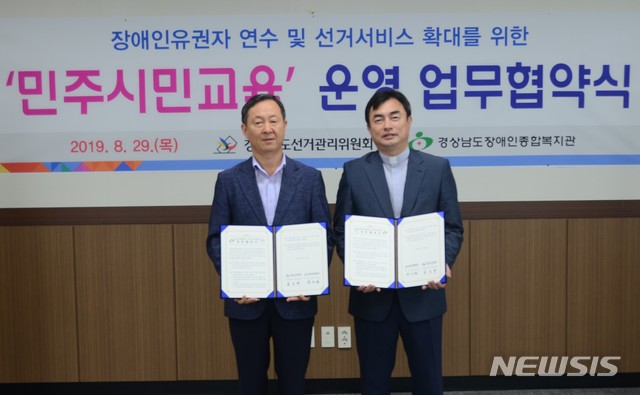 【창원=뉴시스】홍정명 기자= 29일 오전 경상남도선거관리위원회 회의실에서 김종대(왼쪽) 사무처장이 경상남도장애인종합복지관 황인균 관장과 '장애인 유권자 연수 운영 업무협약'을 체결한 후 기념촬영을 하고 있다.2019.08.29.(사진=경남도선관위 제공) photo@newsis.com