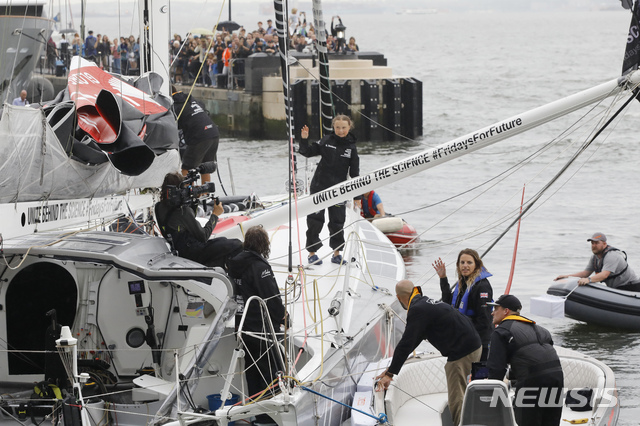 【뉴욕=AP/뉴시스】스웨덴의 10대 환경운동가 그레타 툰베리(16)가 28일(현지시간) 뉴욕항에 입항하면서 요트 위에서 손을 흔들고 있다. 툰베리는 탄소배출을 줄이기 위해 항공편이 아닌 태양광 소형 요트를 타고 지난 14일 영국 플리머스에서 출발해 대서양을 건너 15일 만에 뉴욕에 도착했다. 그는 9월 23일 뉴욕에서 열리는 유엔(UN) 기후 행동 정상회의에 연사로 나선다. 2019.08.29.