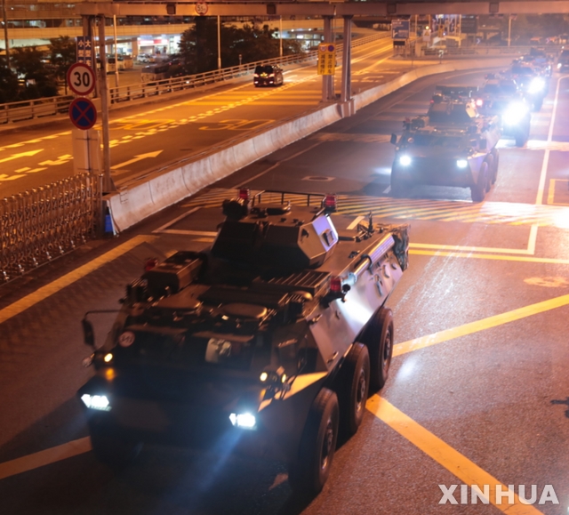 (190829) -- HONG KONG, Aug. 29, 2019 (Xinhua) -- Military vehicles of the Chinese People's Liberation Army (PLA) pass Huanggang Port for a routine troop rotation in south China's Hong Kong, Aug. 29, 2019. The Hong Kong Garrison of the Chinese PLA conducted the 22nd rotation of its members in the wee hours of Thursday since it began garrisoning Hong Kong in 1997. (Photo by Yuan Junmin/Xinhua)