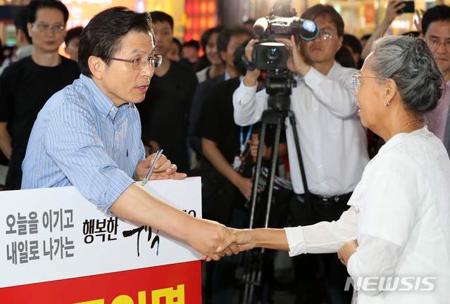 【서울=뉴시스】이영환 기자 = 자유한국당 황교안 대표가 12일 오후 서울 용산구 서울역 광장에서 조국 법무부 장관 임명 철회를 촉구하며 1인 시위를 하던 중 한 지지자와 인사를 나누고 있다. 2019.09.12. 20hwan@newsis.com