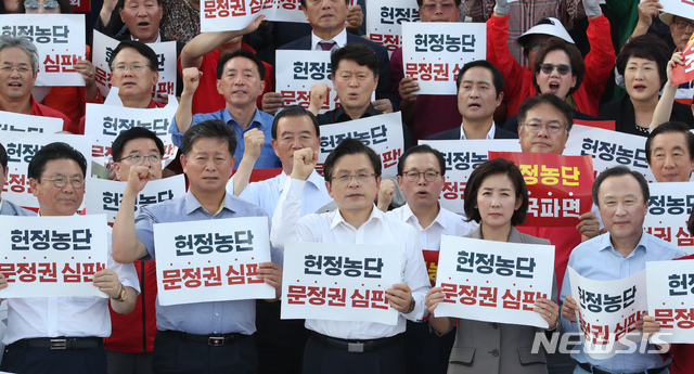 【서울=뉴시스】고승민 기자 = 15일 서울 여의도 국회 앞 계단에서 열린 자유한국당 추석 민심 보고대회에서 황교안 대표와 나경원 원내대표를 비롯한 의원들이 참가자들과 함께 구호를 외치고 있다. 2019.09.15.&nbsp; kkssmm99@newsis.com