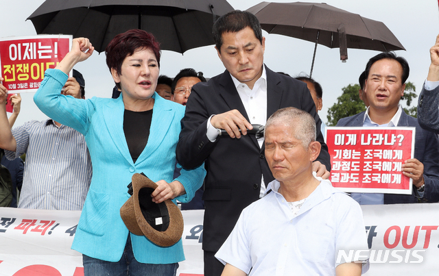 【서울=뉴시스】김병문 기자 = 김문수 전 경기도지사가 17일 오전 서울 종로구 청와대 앞 분수대 광장에서 조국 법무부 장관의 사퇴를 촉구하며 삭발을 하고 있다.&nbsp; 앞줄 왼쪽부터 송영선 전 의원, 자유한국당 박대출 의원, 김 전 도지사. 2019.09.17.&nbsp; dadazon@newsis.com