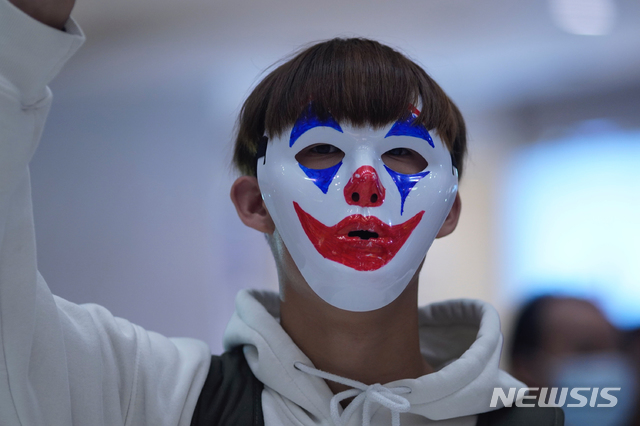  【홍콩=AP/뉴시스】18일(현지시간) 홍콩에서 인간 사슬을 형성하고 시위 중인 한 시위대가 '복면금지법'을 비웃기라도 하듯 다양한 모습의 가면을 쓰고 시위하고 있다. 2019.10.19. 