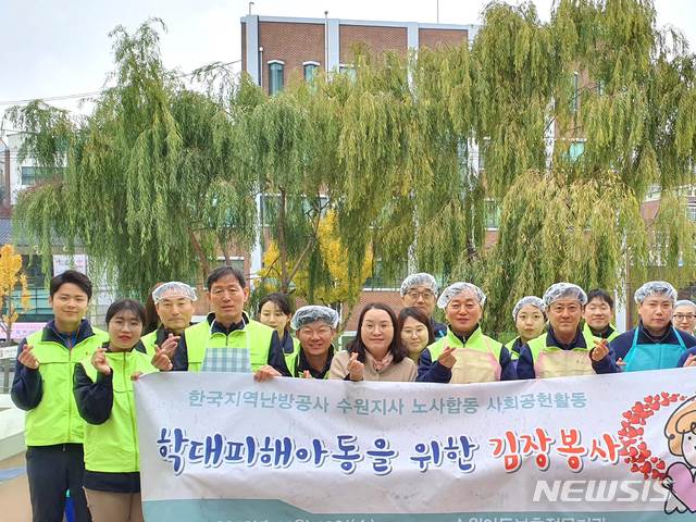 【수원=뉴시스】김경호 기자= 경기 수원아동보호전문기관과 한국지역난방공사 수원지사가 13일 김장 김치 담그기 봉사 기념촬영을 하고 있다. 