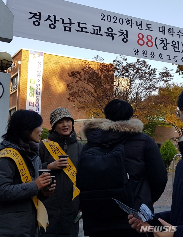 【창원=뉴시스】홍정명 기자=2020학년도 대학수학능력시험일인 14일 경남도교육청 88(창원)지구 제13시험장인 창원용호고등학교 정문에서 학교 인근 창원시민교회 신자들이 수능 응시생에게 준비한 차를 건네며 격려의 말을 전하고 있다.2019.11.14. photo@newsis.com