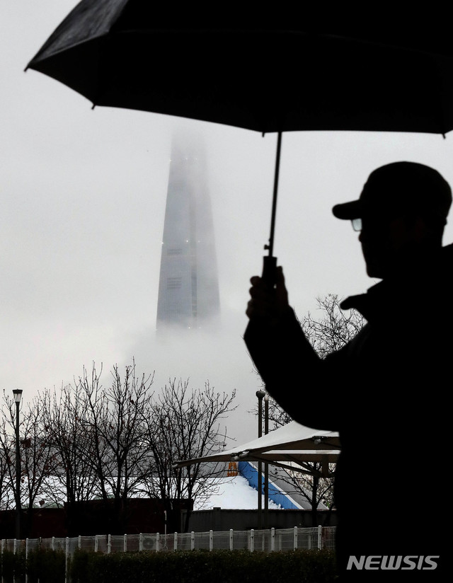 [서울=뉴시스]김병문 기자 = 겨울비가 내리는 7일 오후 서울 광진구 뚝섬한강공원에서 바라본 롯데월드타워가 구름에 가려져 있다. 2020.01.07.&nbsp; dadazon@newsis.com 