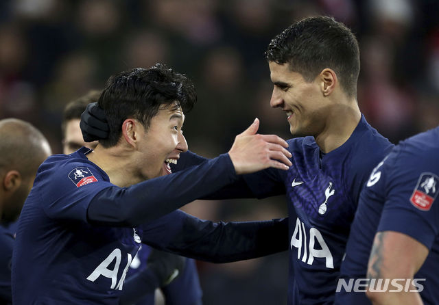 Tottenham Hotspur's Son Heung-min, left, celebrates scoring his side's first goal of the game with team-mate Erik Lamela during the FA Cup fourth round soccer match between Southampton and Tottenham Hotspur at St Mary's Stadium, Southampton, England. Saturday, Jan. 25, 2020. (Steven Paston/PA via AP)