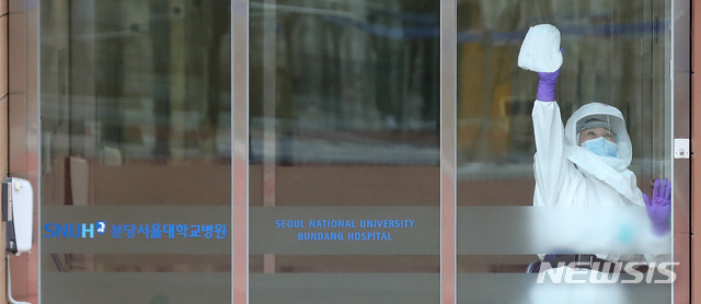 [성남=뉴시스]김선웅 기자 = 28일 경기 성남시 분당서울대병원 내 신종 코로나 바이러스 감염증(우한 폐렴) 국내 네 번째 확진환자가 입원 중인 국가지정 입원치료병상에서 병원 관계자가 출입문을 소독하고 있다. 2020.01.28. mangusta@newsis.com