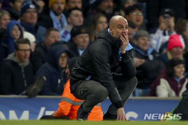Manchester City's head coach Pep Guardiola reacts after a missed chance to score during the English League Cup semifinal second leg soccer match between Manchester City and Manchester United at Etihad stadium in Manchester, England, Wednesday, Jan. 29, 2020. (AP Photo/Dave Thompson)