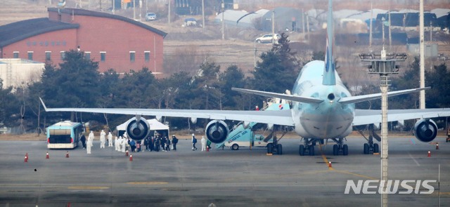 [서울=뉴시스] 고범준 기자 = 신종 코로나바이러스 감염증(우한 폐렴)이 발생한 중국 후베이성 우한 교민들이 탑승한 대한항공 전세기가 31일 오전 서울 강서구 김포국제공항에 도착, 교민들이 버스에 탑승하기 위해 줄 지어 서 있다. 2020.01.31.bjko@newsis.com