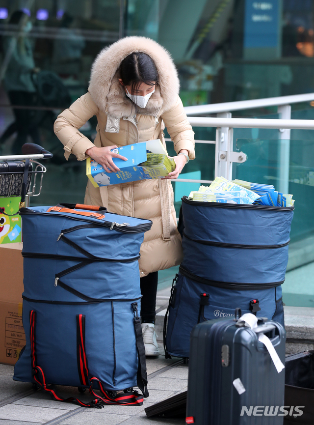 [인천공항=뉴시스]전신 기자 = 신종 코로나바이러스 감염증(우한 폐렴) 확산에 따른 마스크 품귀 현상이 빚어지는 가운데 4일 인천국제공항 출국장 앞에서 한 중국인이 대량의 마스크를 가방에 담고 있다. 2020.02.04.  photo1006@newsis.com