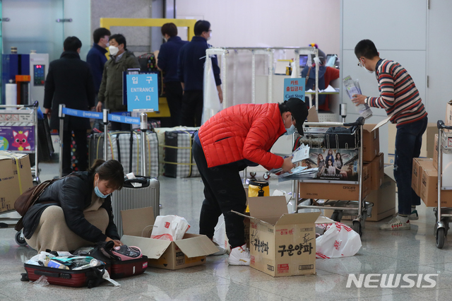 [인천공항=뉴시스]전신 기자 = 신종 코로나바이러스 감염증 확산에 따른 마스크 품귀 현상이 빚어지는 가운데 지난 4일 인천국제공항 출국장에서 외국인들이 마스크를 가방에 담고 있다. 2020.02.04.  photo1006@newsis.com