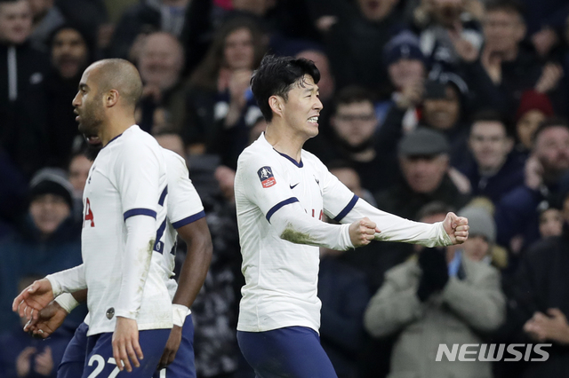 Tottenham's Son Heung-min, right, celebrates after scoring his side's third goal during the English FA Cup fourth round replay soccer match between Tottenham Hotspur and Southampton at the Tottenham Hotspur Stadium in London, Wednesday, Feb. 5, 2020. (AP Photo/Kirsty Wigglesworth)