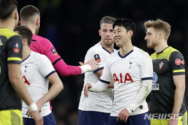 Tottenham's Son Heung-min, 2nd right, shakes hands with Southampton's goalkeeper Angus Gunn at the end of the English FA Cup fourth round replay soccer match between Tottenham Hotspur and Southampton at the Tottenham Hotspur Stadium in London, Wednesday, Feb. 5, 2020. Son scored the winning goal in Tottenham's 3-2 win. (AP Photo/Kirsty Wigglesworth)