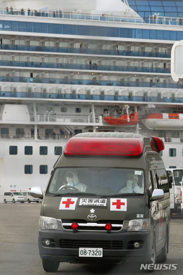  [요코하마=AP/뉴시스]14일 유람선 다이아몬드 프린세스호가 정박 중인 일본 도쿄 인근 요코하마항에서 구급차 한 대가 나오고 있다. 승객과 승무원 약 3500명이 탑승한 이 유람선에서 신종 코로나바이러스 감염증(코로나19) 확진자가 218명으로 늘어나면서 일본 정부의 대처에 대해 국제사회의 비판이 고조되고 있다. 일본은 80세 이상 고령자와 지병이 있는 탑승자 등에 대해 코로나19 검사 후 음성으로 확인되면 이들을 먼저 하선시킨다는 계획이다. 2020.02.14.&nbsp; 
