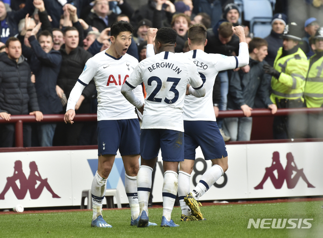Tottenham's Son Heung-min, left, celebrates after scoring his side's third goal during the English Premier League soccer match between Aston Villa and Tottenham Hotspur at Villa Park in Birmingham, England, Sunday, Feb. 16, 2020. (AP Photo/Rui Vieira)