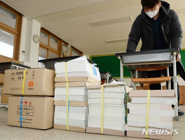 [전주=뉴시스] 김얼 기자= 신종 코로나바이러스 감염증(코로나19)의 여파로 전국의 학교가 휴업한 2일 전북 전주시 전주동초등학교에서 한 교사가 미루어진 개학을 앞두고 살균제로 학생들이 사용할 책상을 닦고 있다. 2020.03.02.pmkeul@newsis.com