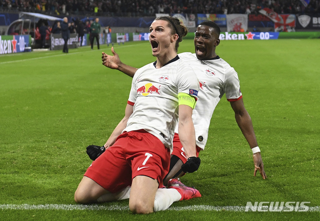 Leipzig's Marcel Sabitzer, center, celebrates after scoring a goal during the Champions League round of 16, 2nd leg soccer match between RB Leipzig and Tottenham Hotspur in Leipzig, Germany, Tuesday, March 10, 2020. (Hendrik Schmidt/dpa via AP)