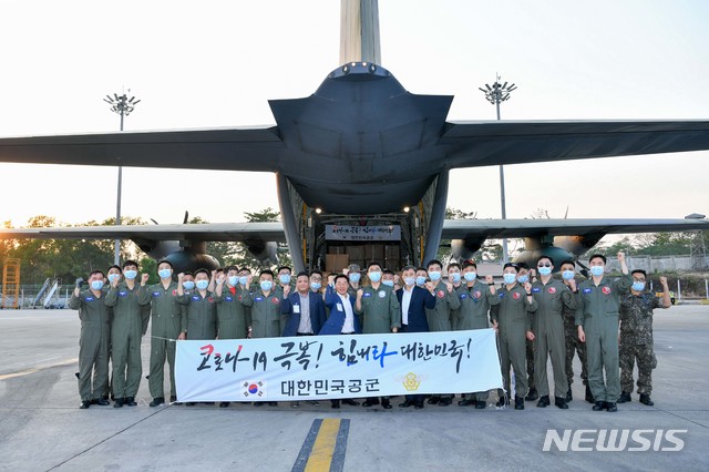 [서울=뉴시스]18일(현지시간) 미얀마 양곤 국제공항에서 방역물자를 적재한 공군 제5공중기동비행단 장병들이 미얀마 관계자들과 기념촬영을 하고 있다. (사진=공군 제공) 2020.03.19.photo@newsis.com