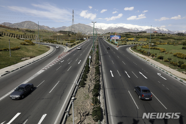 Cars drive in a highway in northern Tehran, Iran, Friday, March 20, 2020, on the first day of Iranian New Year, called Nowruz, or "New Day" in Farsi, the Persian holiday marking the the spring equinox. The new coronavirus has cut into the ancient Nowruz and has further slowed the Islamic Republic's economy. (AP Photo/Vahid Salemi)