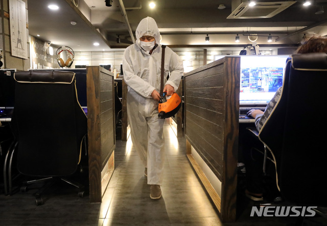 [서울=뉴시스] 전진환 기자 = 한국방역협회 봉사단원들이 21일 오전 서울 종로구의 한 PC방에서 신종 코로나바이러스 감염증(코로나19) 예방을 위한 방역 작업을 하고 있다. 2020.03.21.&nbsp; amin2@newsis.com
