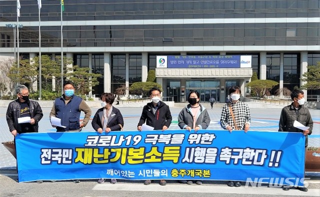 [충주=뉴시스]이병찬 기자 = 충북 충주 개혁국민운동본부가 25일 충주시청 광장에서 전국민 재난기본소득 지급을 촉구하고 있다.2020.03.25.bclee@newsis.com