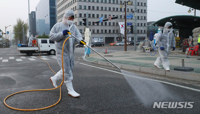 [서울=뉴시스] 장세영 기자 = 영등포구청 방역요원들이 지난 4일 서울 여의도 국회 앞 도로에서 코로나19 관련 방역을 펼치고 있다. 2020.04.04. photothink@newsis.com
