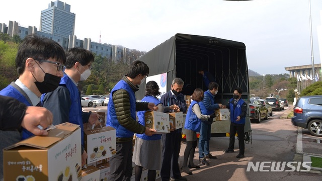 [세종=뉴시스] 한국자유총연맹 회원들이 신종 코로나바이러스 감염증(코로나19)으로 어려움을 겪는 지역 주민들에게 물품을 나눠주고 있다. (사진= 행정안전부 제공) 2020.04.07. 