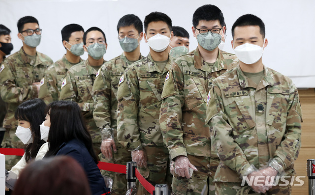 [서울=뉴시스] 이영환 기자 = 카투사 장병들이 제21대 국회의원선거 사전투표 시작일인 10일 오전 서울 용산구 용산구의회에 마련된 이태원제1동 사전투표소에서 사전투표를 하기 위해 비닐장갑을 착용한채 대기하고 있다. 2020.04.10.   20hwan@newsis.com