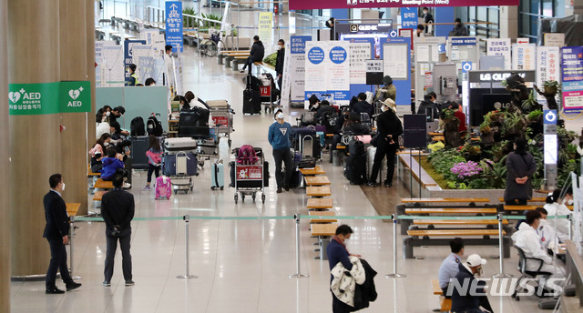 [인천공항=뉴시스]박주성 기자 = 국내에 첫 신종 코로나바이러스 감염증(코로나19) 확진환자가 발생한지 100일째인 지난달 28일 오전 인천공항 제1여객터미널 입국장에 마련된 해외입국자 버스 대기장소에서 입국한 시민들이 버스를 기다리고 있다. 코로나 19의 직격탄을 맞은 인천공항은 예년보다 이용객이 95%이상 급감해 일평균 3000~4000명이 이용할 정도로 한산하다. 2020.04.28. park7691@newsis.com