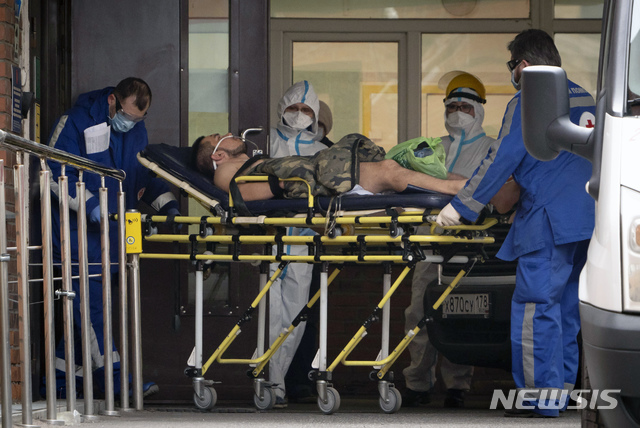 [상트페테르부르크=AP/뉴시스]28일(현지시간) 의료진이 신종 코로나바이러스 감염증(코로나19)에 걸린 것으로 의심되는 환자를 포크로프스카야 병원으로 옮기고 있다. 블라디미르 푸틴 대통령은 코로나19 억제를 위한 전국 휴무령을 5월 11일까지 연장한다고 밝혔다. 2020.04.29.