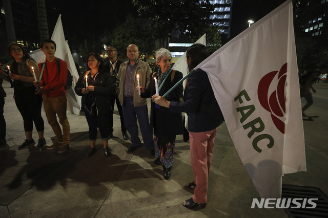 [보고타( 콜롬비아)= AP/뉴시스] 콜롬비아 반군 단체 출신의 정당인 콜롬비아 대안혁명당 사람들이 지난 3월 8일 정부와의 평화협정에 나섰다는 이유로 살해당한 당원의 장례식에 모여 정부의 보호조처가 미흡했다며 항의하고 있다.  