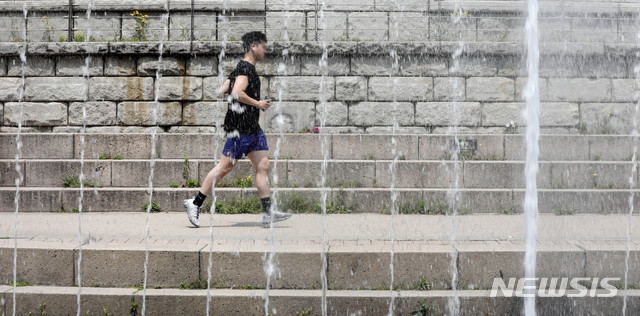 [서울=뉴시스]김병문 기자 = 초여름 날씨를 보이는 지난 1일 오후 서울 종로구 청계천에서 한 시민이 운동을 하고 있다. 2020.05.01. dadazon@newsis.com