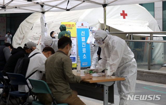 [서울=뉴시스] 이윤청 기자 = 이태원 클럽 집단 감염 영향으로 신종 코로나바이러스 감염증(코로나19) 확산이 우려되는 가운데 11일 서울 용산구보건소 선별진료소에서 시민들이 문진표를 작성하고 있다. 2020.05.11. radiohead@newsis.com