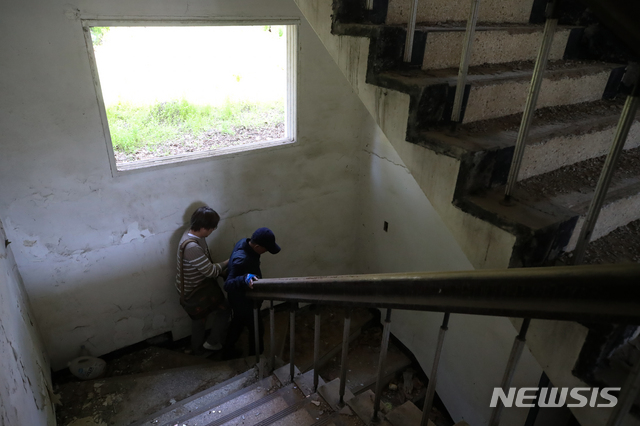 [광주=뉴시스] 조수정 기자 =&nbsp; 5·18 광주민주화운동 40년을 앞두고 24일 광주 서구 쌍촌동 옛 505 보안부대 터를 찾은 이성전 씨가 트라우마 치유를 위해 사진심리치유자 임종진 씨와 함께 자신이 고문을 당한 장소로 들어가고 있다. 5·18 당시 시민군으로 활동하던 이 씨는 계엄군에 의해 이곳으로 끌려와 모진 고문을 당했다. 지금은 사진으로 공간을 대면하는 트라우마 치유를 하고 있다. 2020.04.24. chocrystal@newsis.com
