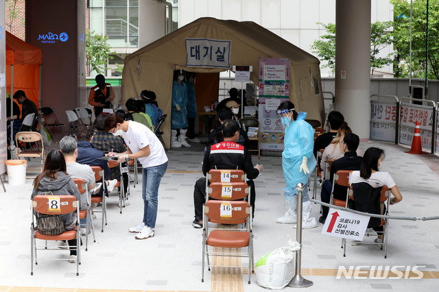 [서울=뉴시스]김병문 기자 = 홍대 일대에 소재한 한신포차와 1943 등 주점 2곳 등에서 5명의 신종 코로나바이러스 감염증(코로나19) 확진자가 나온 가운데 14일 오후 서울 마포구 보건소 선별진료소가 시민들로 붐비고 있다. 2020.05.14. dadazon@newsis.com