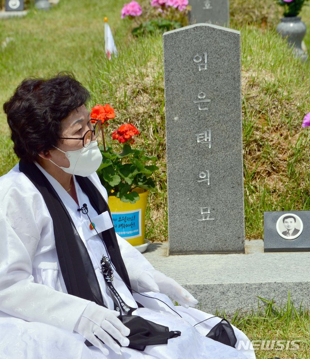 [광주=뉴시스] 변재훈 기자 = 5·18 민주화운동 40주년을 하루 앞두고 추모제가 열린 17일 광주 북구 운정동 국립 5·18민주묘지에서 유족 최정희(73)씨가 항쟁 당시 숨진 남편 임은택씨의 묘 앞에서 오열하고 있다. 2020.05.17. wisdom21@newsis.com