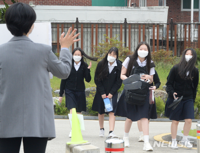 [전주=뉴시스] 김얼 기자 = 고등학교 3학년 학생부터 순차적으로 등교 수업을 시작한 20일 전북 전주시 전주여자고등학교에서 학생들이 선생님과 인사를 나누고 있다. 2020.05.20.pmkeul@newsis.com